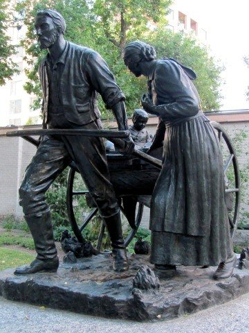 Bronze sculpture of a handcart pioneer family